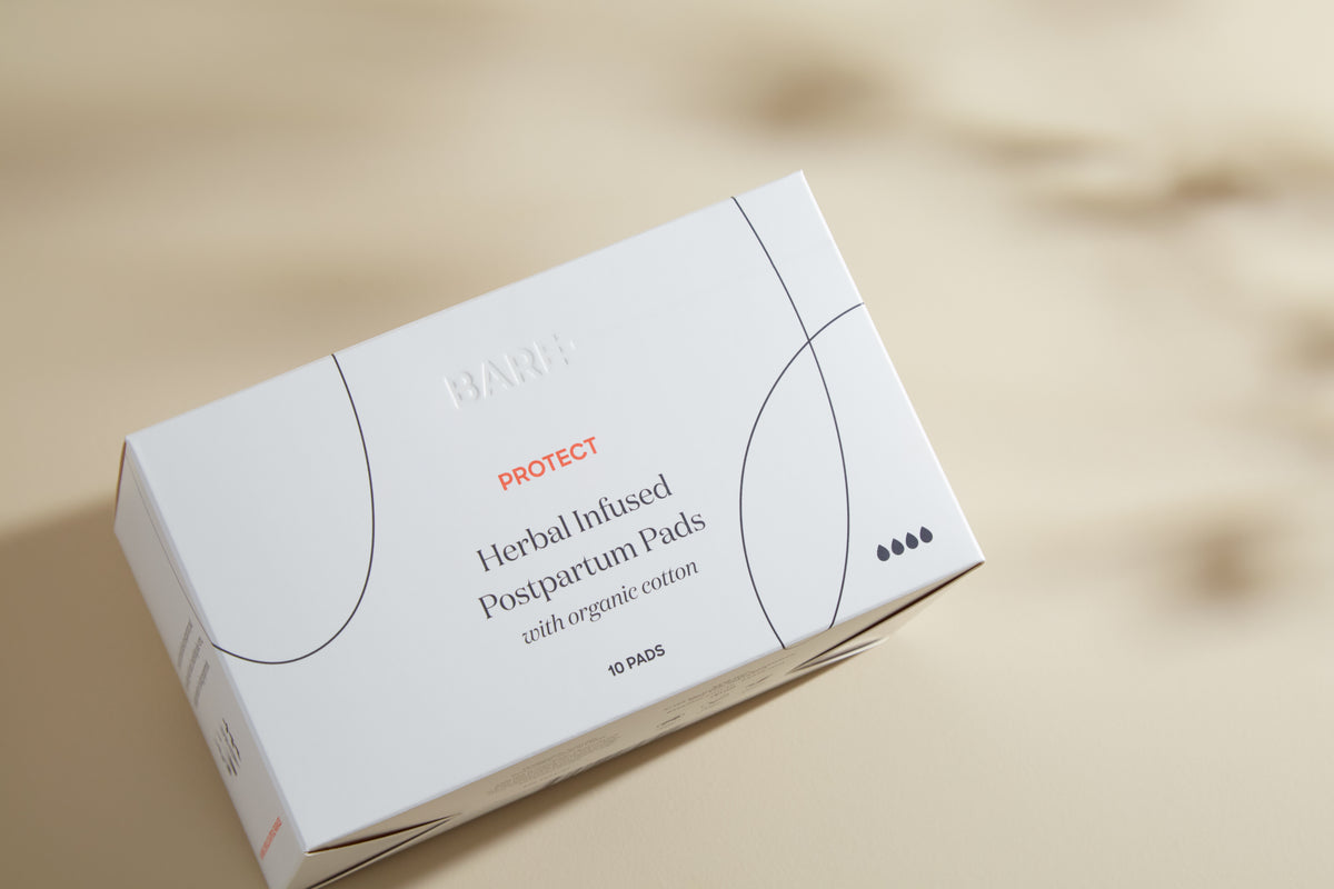 Close-up of the Bare Mum Herbal Infused Postpartum Pads box, organic cotton pads for postpartum bleeding
