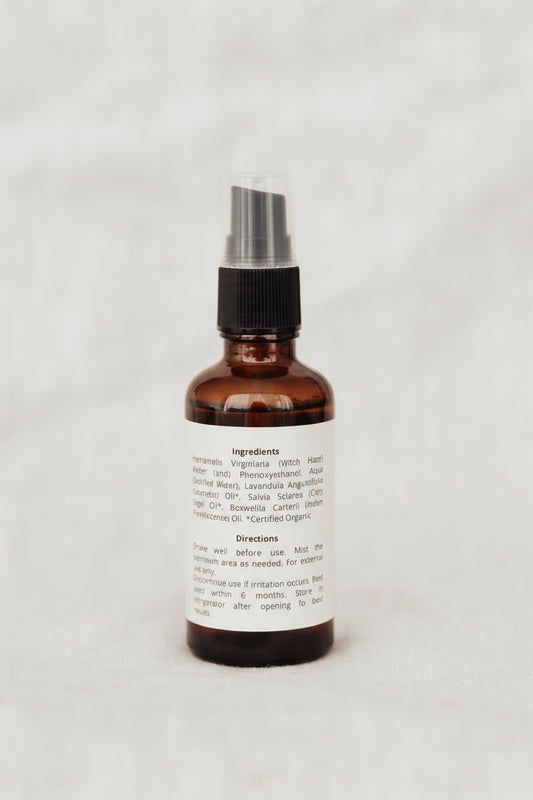Brown spray bottle with a label on a white background