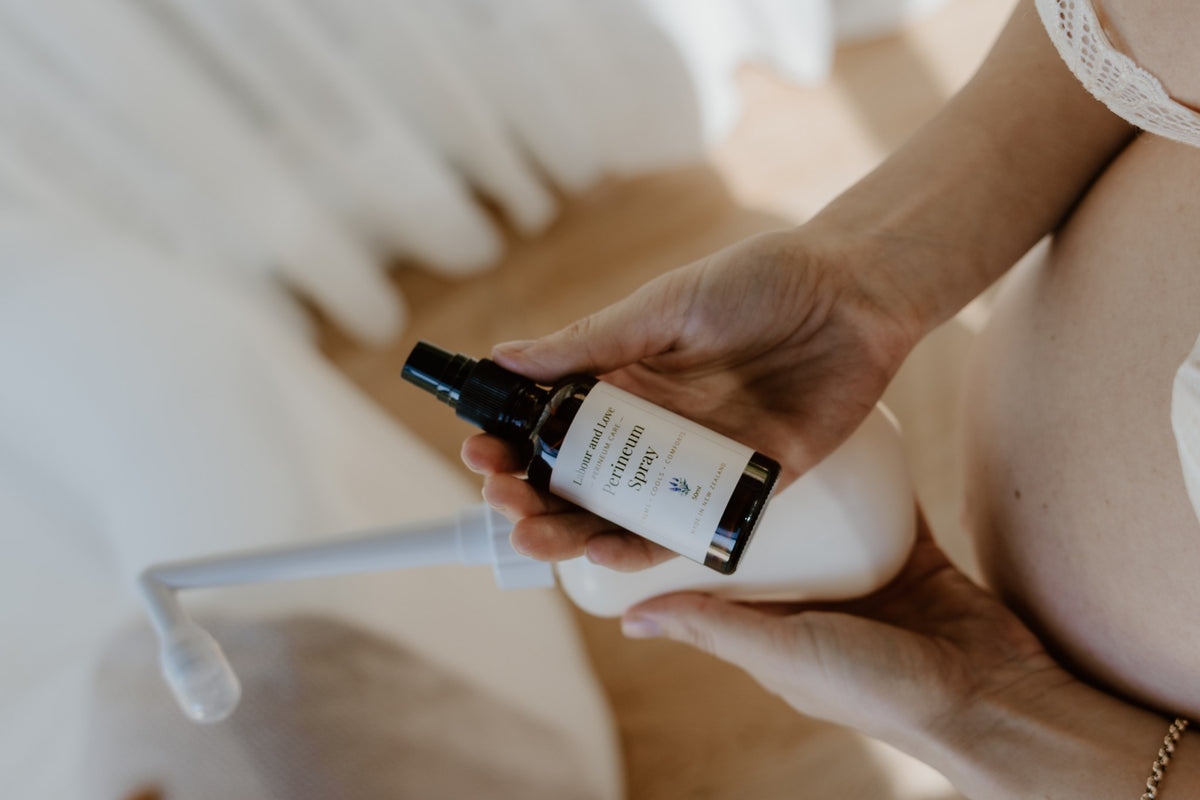 Hands holding Labour & Love Perineum Relief Spray with a peri bottle, alcohol-free witch hazel postpartum spray