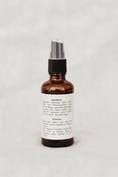 Brown spray bottle with a label on a white background