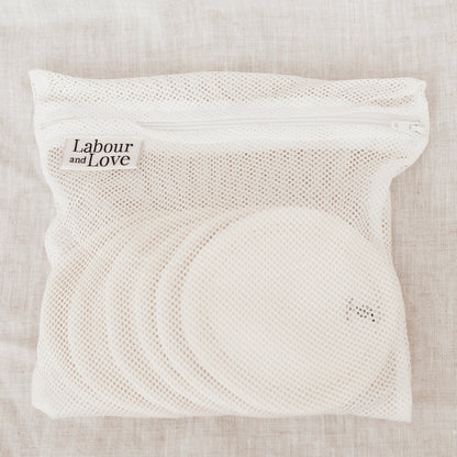 White mesh bag with 'Labour and Love' branding on a beige fabric background