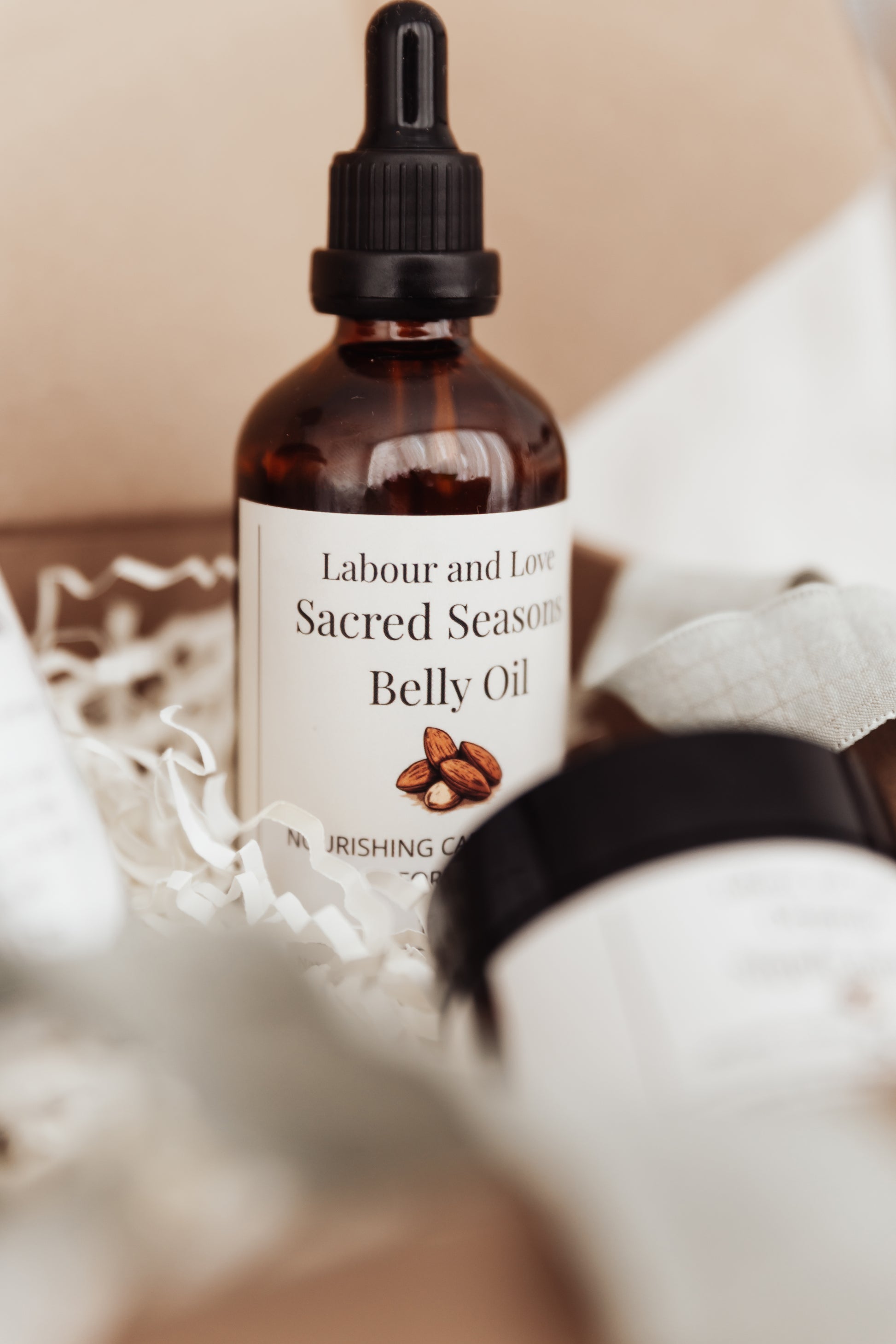 Bottle of Labour and Love Sacred Seasons Belly Oil with a dropper on a neutral background
