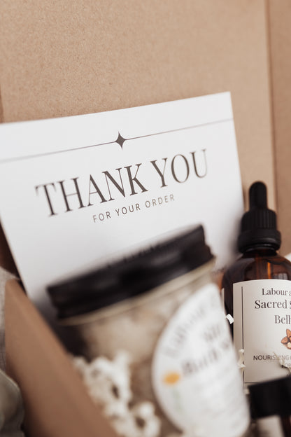 Bottle of Labour and Love Sacred Seasons Belly Oil with a 'Thank You for Your Order' card in a box.