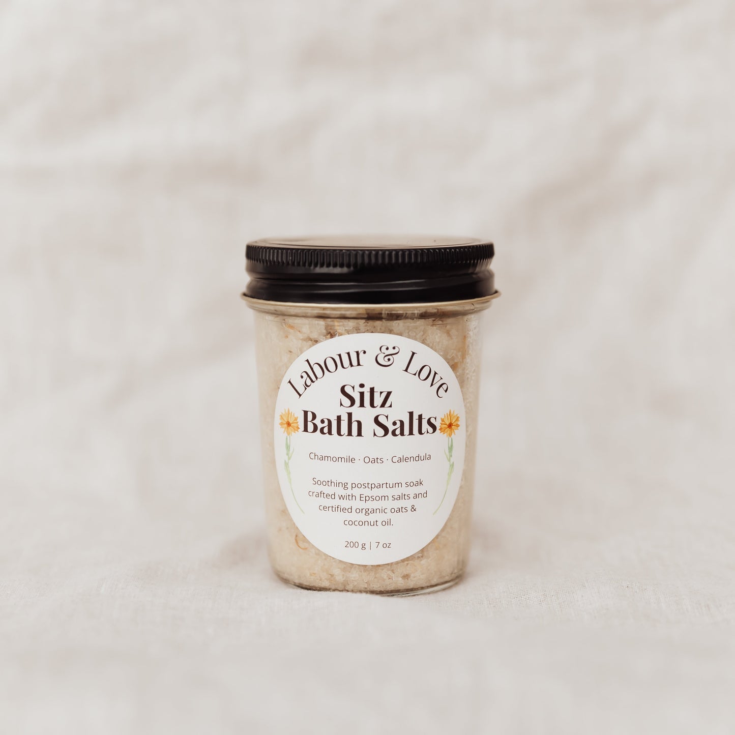 Jar of Labour and Love Sitz Bath Salts with a label on a light background