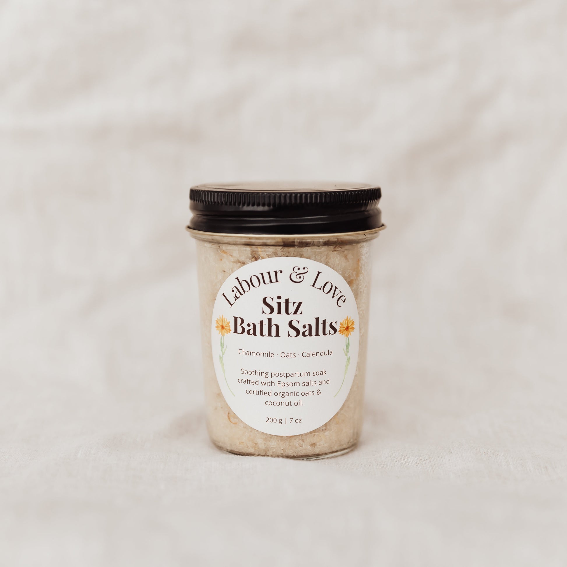 Jar of Labour and Love Sitz Bath Salts with a label on a light background