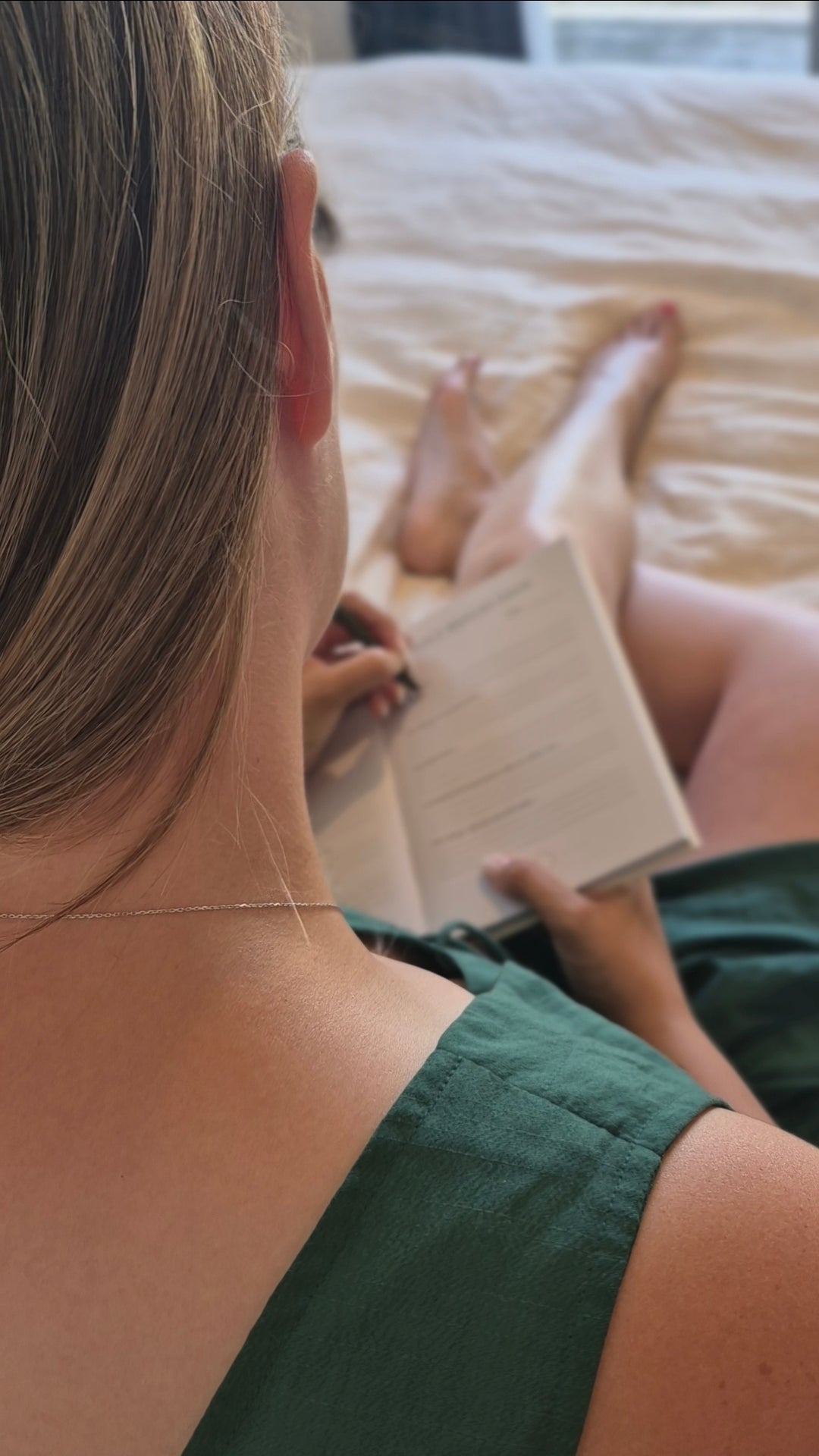 Woman writing in the Labour and Love postpartum journal — a reflective keepsake for new mums in the fourth trimester