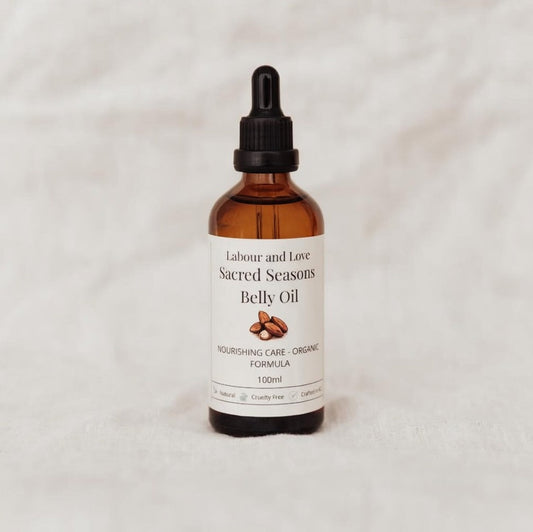 Organic Sacred Seasons Belly Oil by Labour and Love for pregnancy and sacred recovery, showing a bottle with natural ingredients.